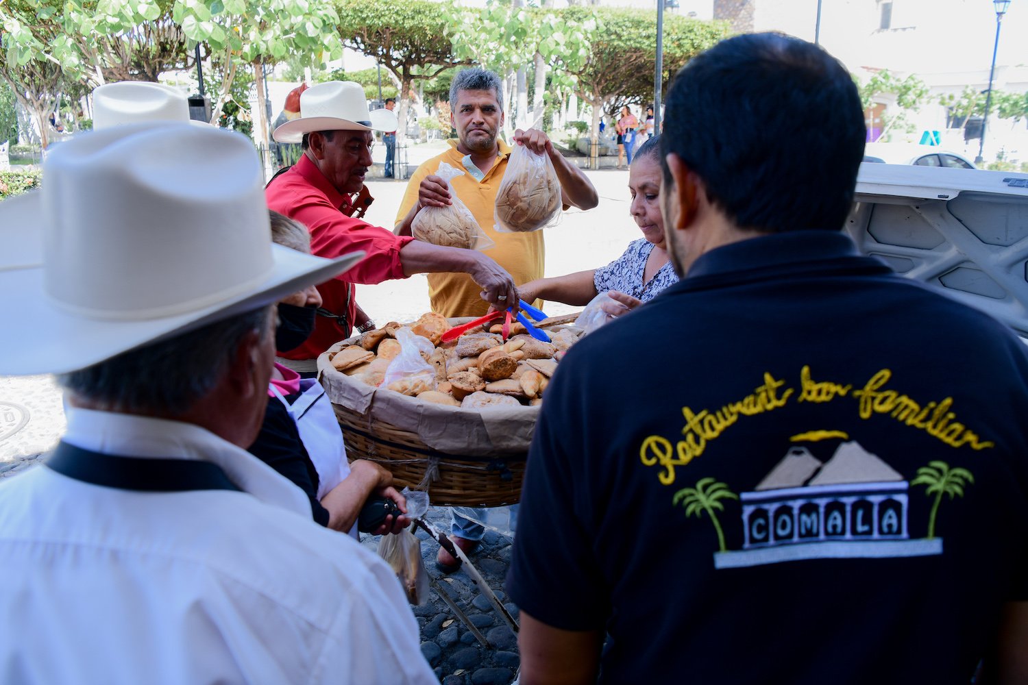 People handing out bread in Comala, Mexico